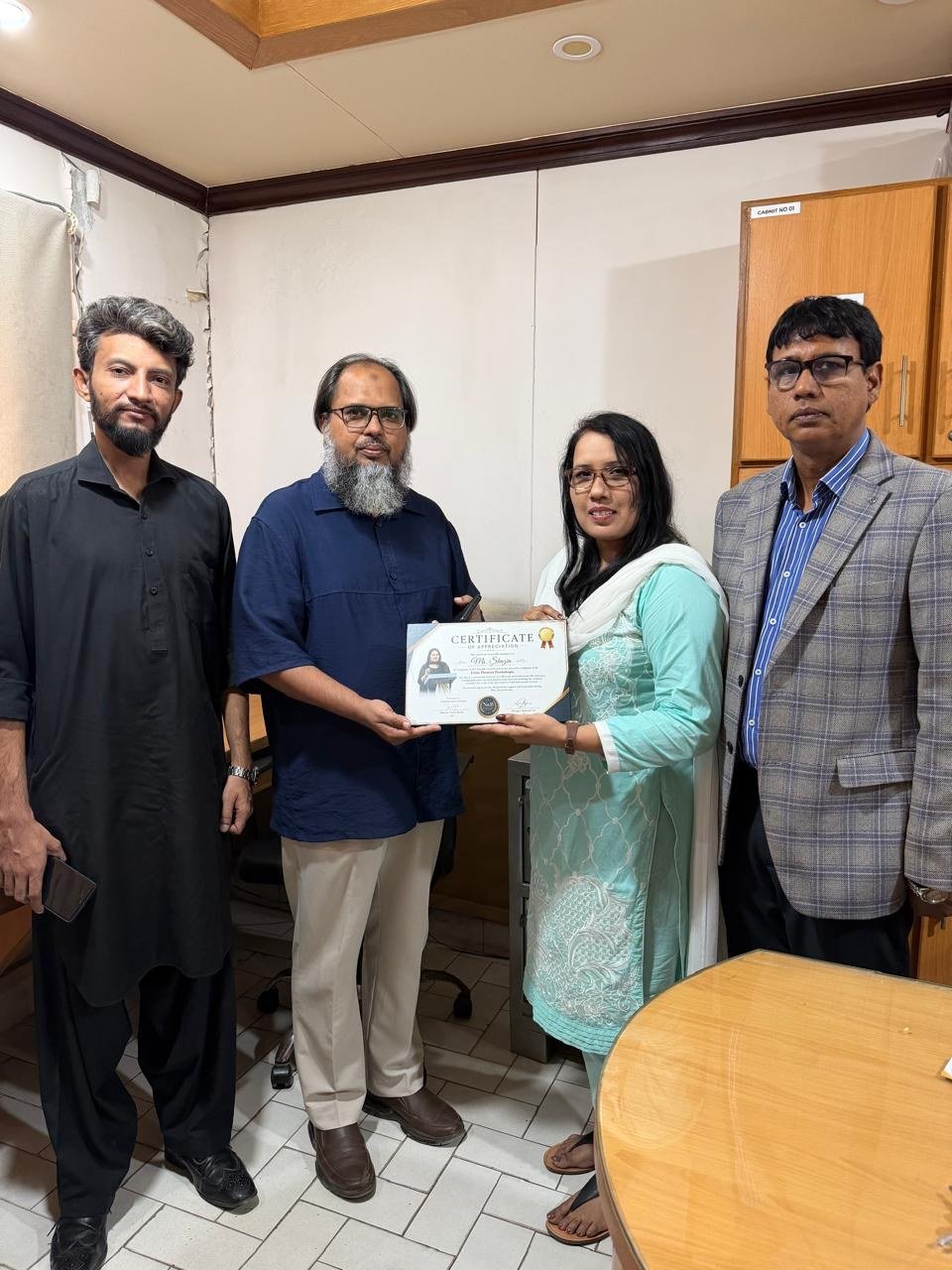 Certificate of Appreciation being presented to Ms. Shazia